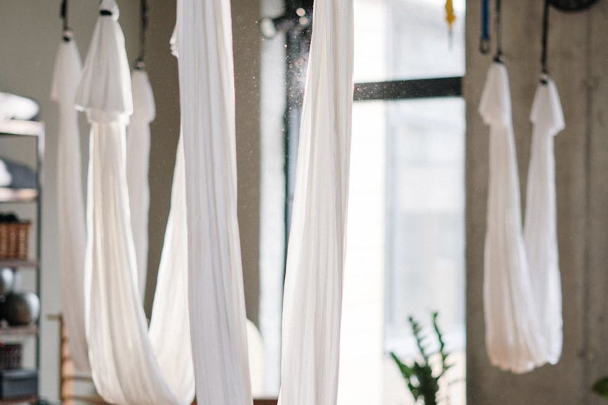 Person practicing yoga in a dark aesthetic studio